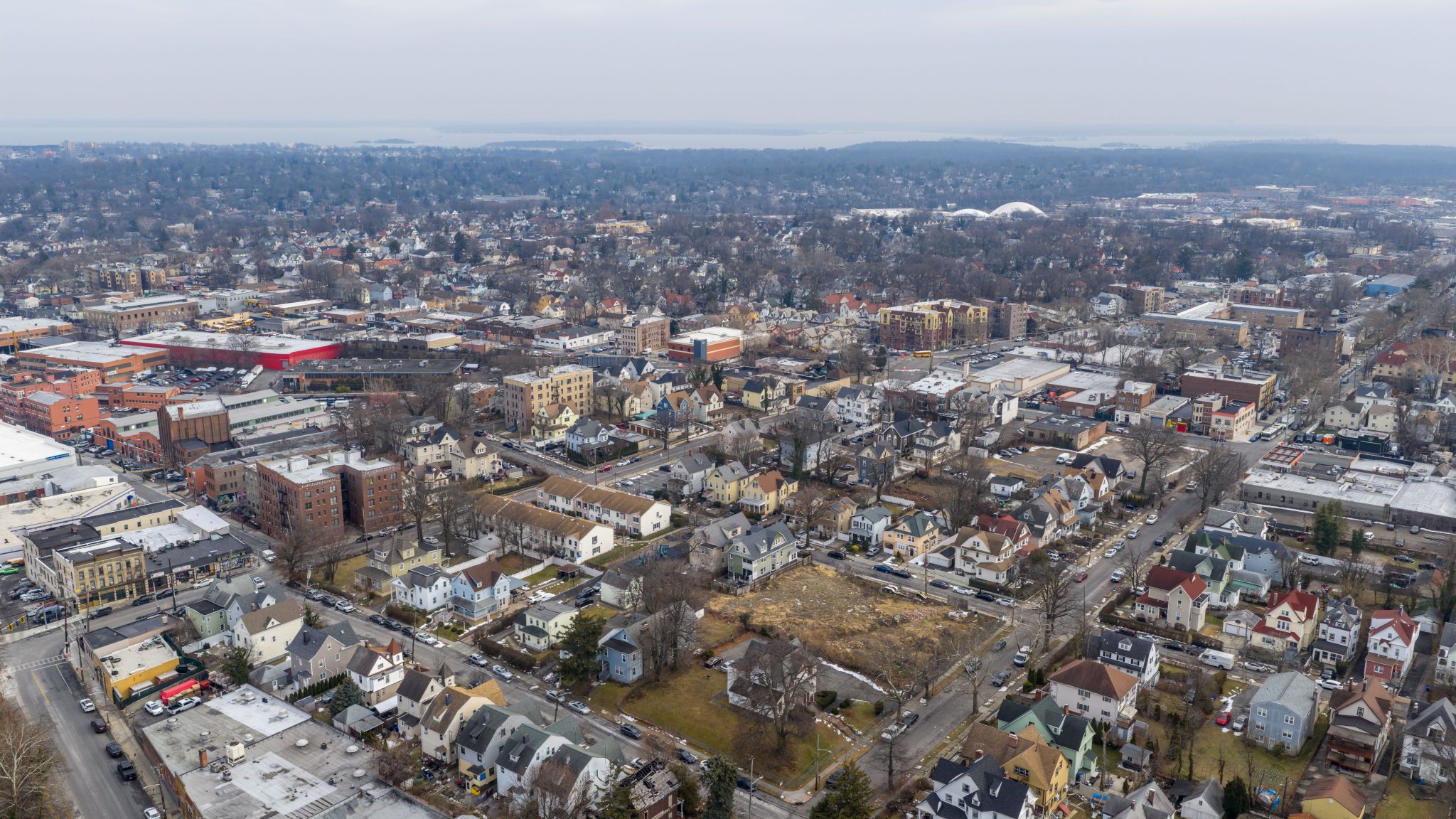 Foggy aerial drone photo of Mount Vernon New York with overcast winter sky and dense neighborhoods, image 5